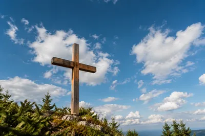 Weathered Empty Cross Under Blue Sky