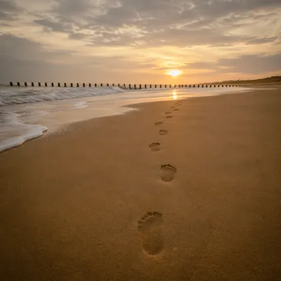 Sunrise Footprints Across a Quiet Beach