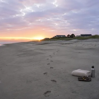 Footprints on Sunrise Beach with Dune Grass