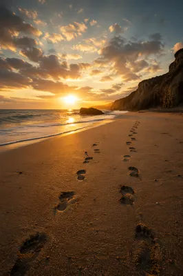 Footprints Toward Sunrise on Quiet Beach