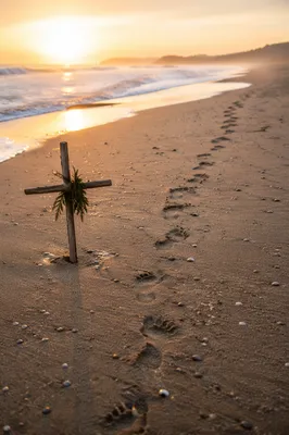 Footprints Toward Sunrise With Driftwood Cross