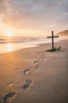 Footprints Leading to Driftwood Cross at Sunrise