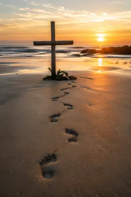 Footprints to Driftwood Cross at Sunrise