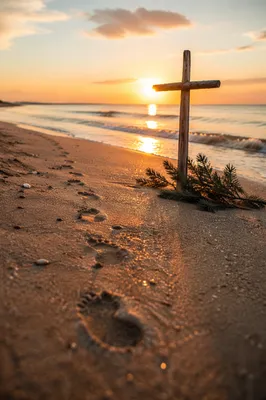 Footprints Toward Cross at Beach Sunrise