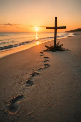 Footprints Leading to Driftwood Cross at Sunrise
