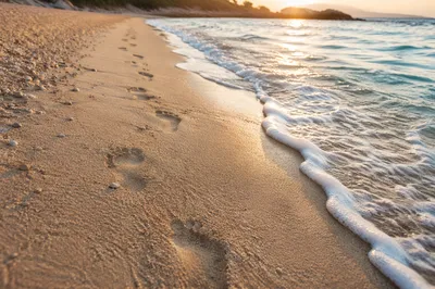 Footprints in Sand at Peaceful Sunrise