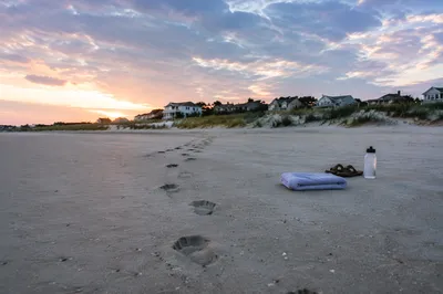 Footprints on Quiet Beach at Sunrise