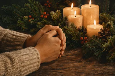 Folded Hands in Prayer by Candlelight