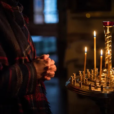 Candlelit Hands Folded in Quiet Prayer
