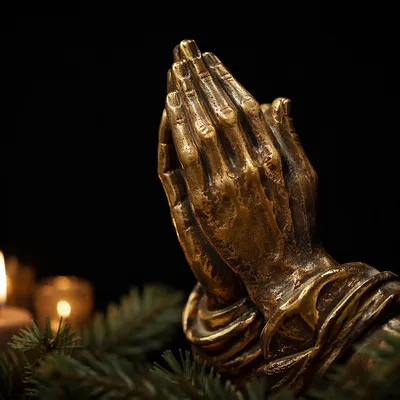 Candlelit Bronze Praying Hands with Evergreen