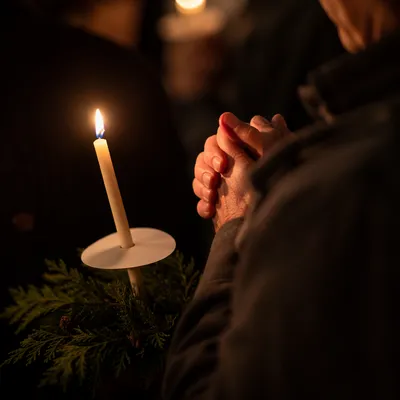 Folded Prayer Hands by Candlelight