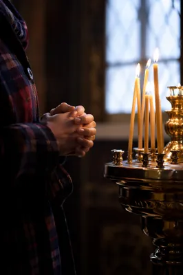 Candlelit Hands Folded in Quiet Prayer