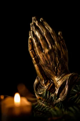 Candlelit Bronze Praying Hands with Evergreen