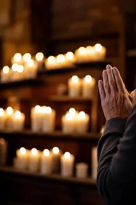 Hands Folded in Prayer by Candlelight