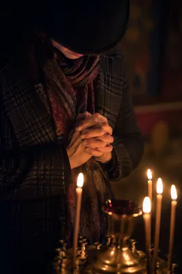 Folded Hands in Candlelight Prayer