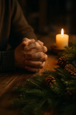 Candlelit Praying Hands with Evergreen Sprigs