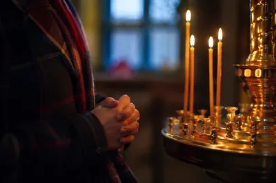 Candlelit Hands Folded in Quiet Prayer