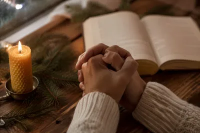 Prayer Hands by Candlelight with Evergreen