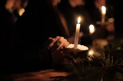 Candlelit Folded Hands in Winter Prayer