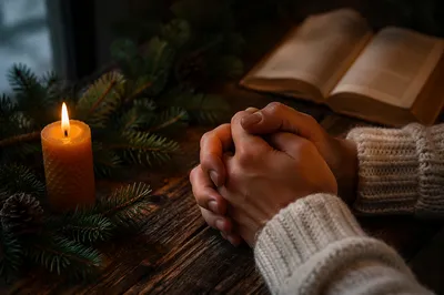Folded Prayer Hands in Evergreen Candlelight
