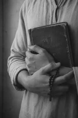 Hands Holding Worn Bible in Prayer