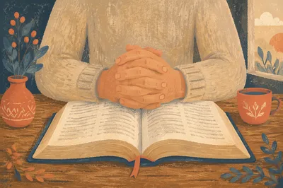 Clasped Hands Over Open Bible