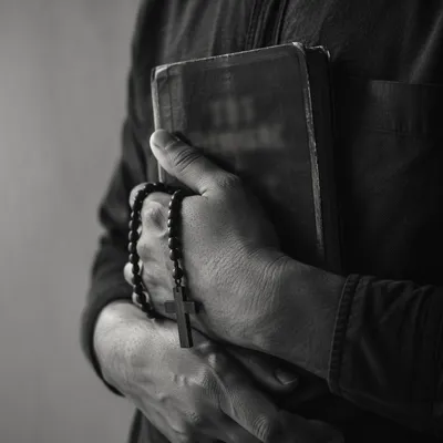 Reverent Hands Holding Worn Bible