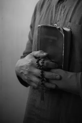 Reverent Hands Holding Worn Bible