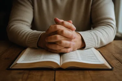 Clasped Hands Over Open Bible Devotion