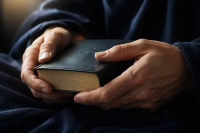 Bible Held in Quiet Reflection