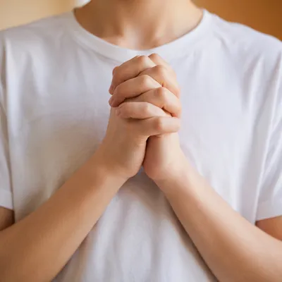 Clasped Hands Praying in Soft Daylight