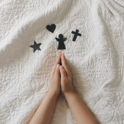 Child Praying Hands in Soft Window Light