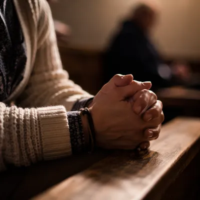 Hands Praying in Soft Warm Light