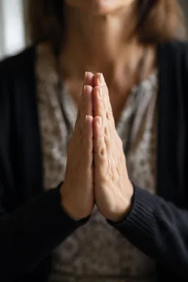 Hands Praying in Gentle Window Light