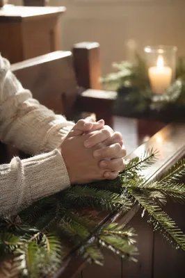 Praying Hands with Evergreen and Candlelight