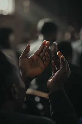 Dark Hands Raised in Soft Prayer
