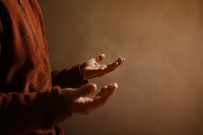 Open Hands in Soft Prayer Light