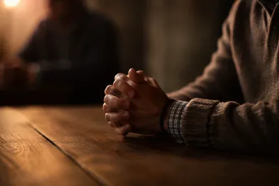 Clasped Hands in Warm Prayer Light