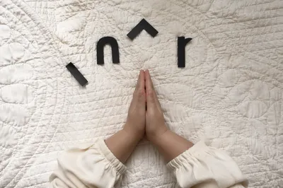 Child Hands Praying in Soft Window Light