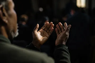 Dark Hands Raised in Quiet Prayer
