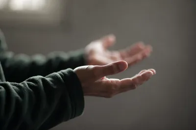 Open Hands in Soft Prayer Light