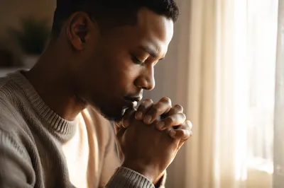 Young Man Praying by Sunlit Window