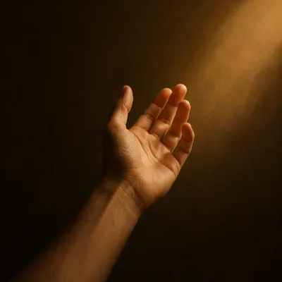 Hand Reaching Toward Warm Hopeful Light