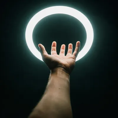 Hand Reaching Toward Halo Light
