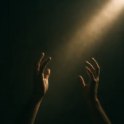 Hands Reaching Toward Warm Light
