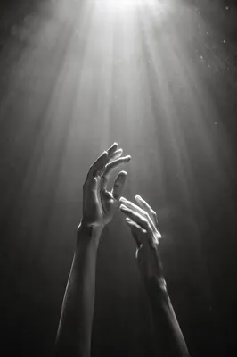 Hands Reaching Toward Heavenly Light