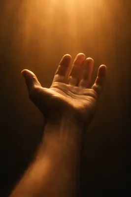 Open Hand Reaching Toward Hopeful Light