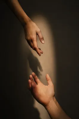 Hands Reaching Toward Hopeful Light
