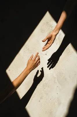 Hands Reaching Toward Hopeful Sunlight