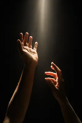 Hands Reaching Toward Divine Light
